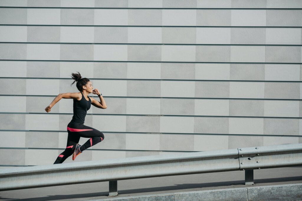 A runner moving at speed alongside an urban wall